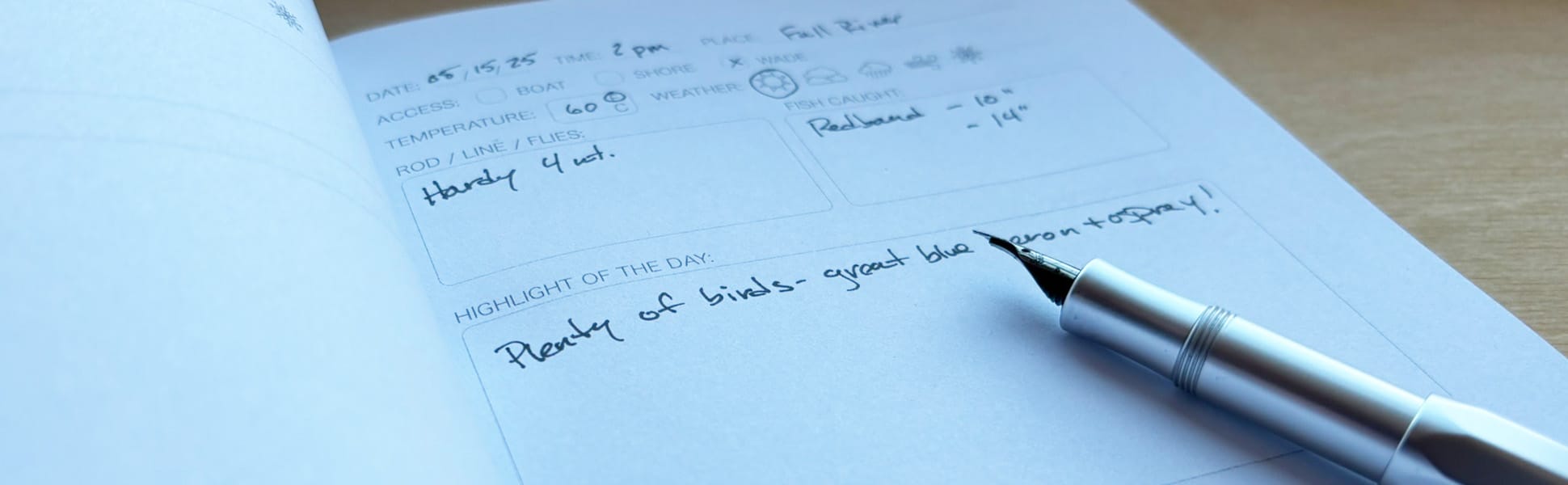 A pen resting on the inside page of Fishing Notes