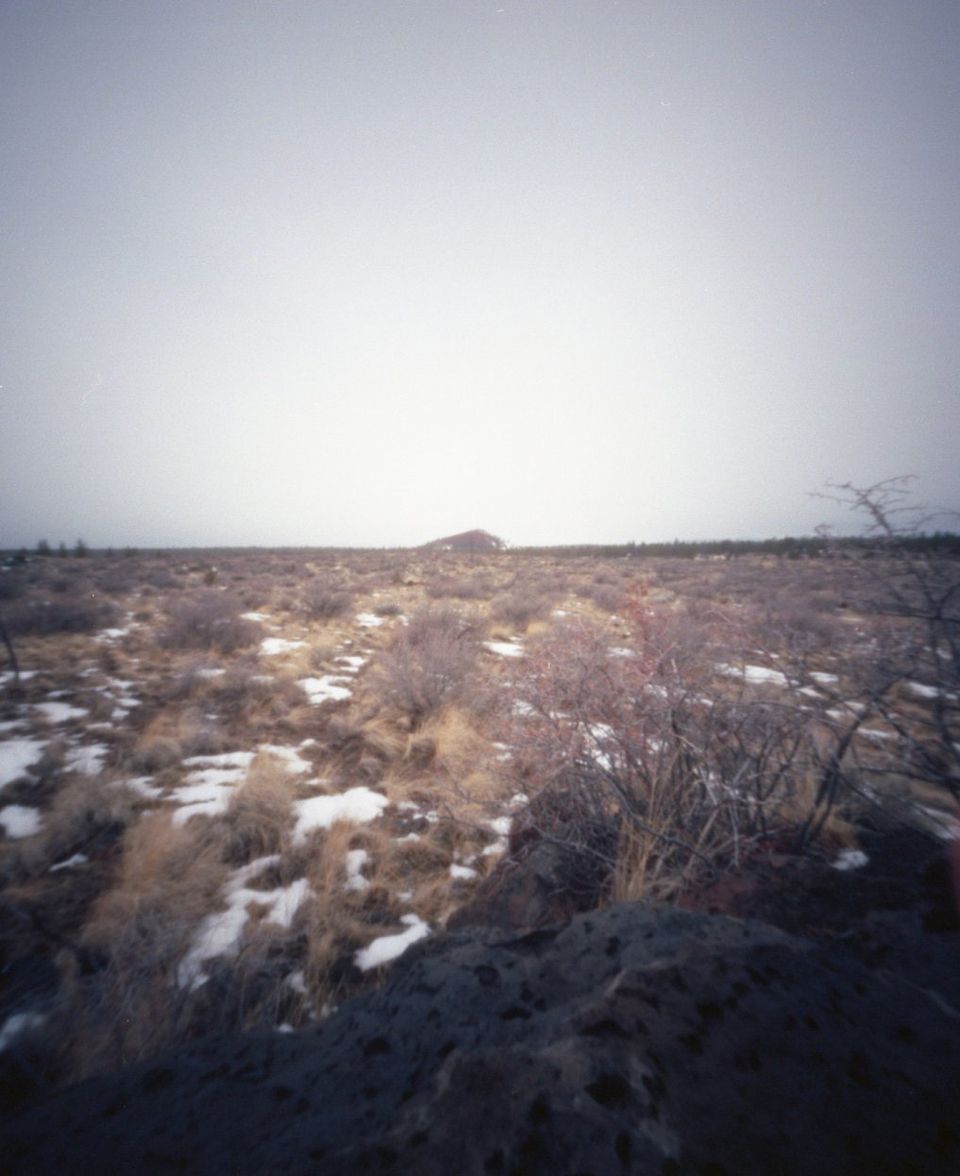 Horse Butte in the distance of a pinhole photo